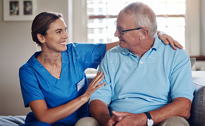 Buy stock photo Shot of a senior man being cared for by a young nurse at home