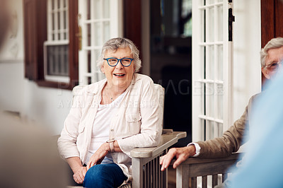 Buy stock photo Cropped shot of a group of senior citizens sitting together and enjoying a day out on the veranda
