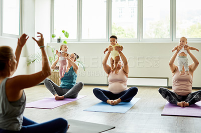 Buy stock photo Cropped shot of a young group of mothers sitting with their babies during a baby yoga class indoors