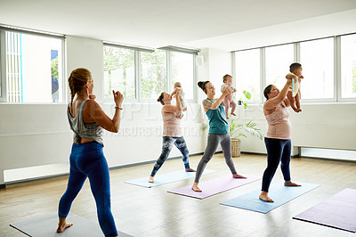 Buy stock photo Cropped shot of a group of mothers holding their babies during a baby yoga class indoors