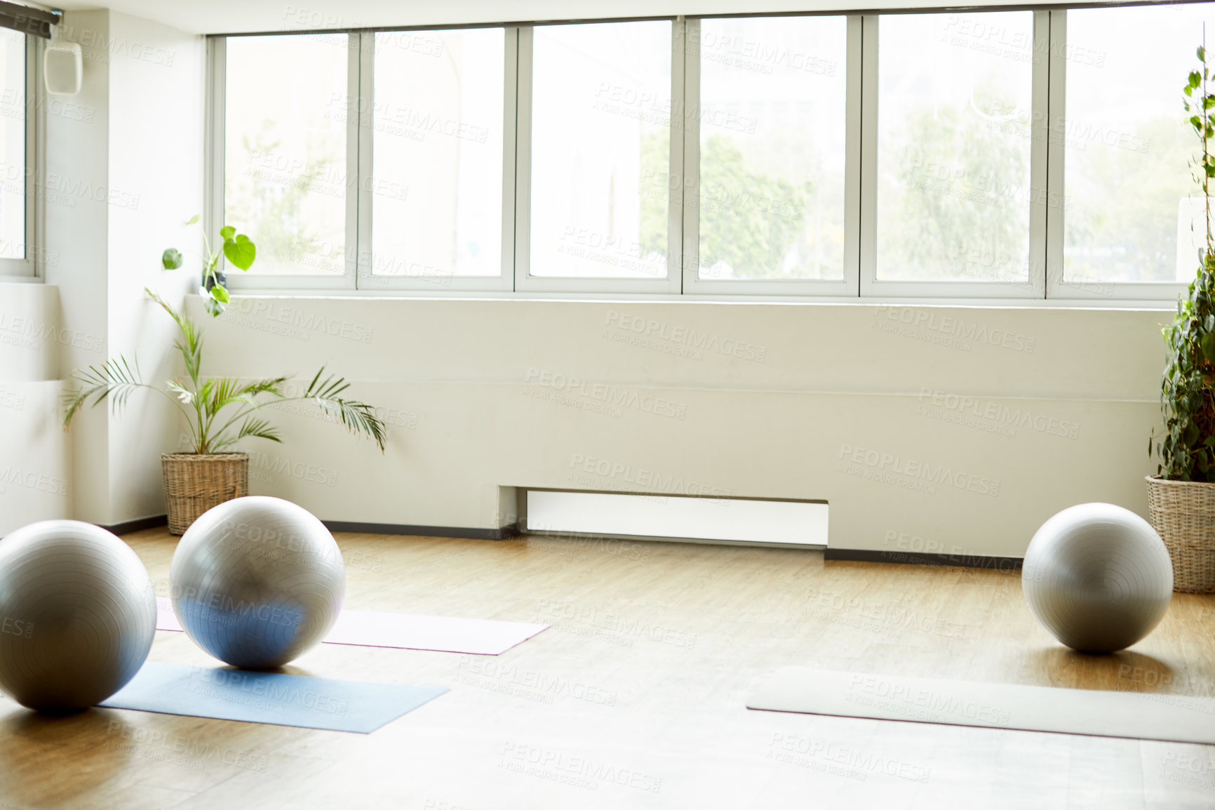 Buy stock photo Cropped shot of a group of yoga balls and mats laid out before a baby yoga class in the studio