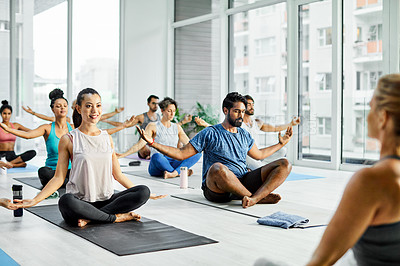 Buy stock photo Shot of a group of men and women meditating during a yoga class
