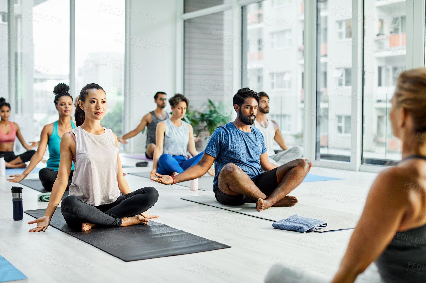 Buy stock photo Instructor, people and yoga class with easy pose, guided session or grounding practice for posture. Mindfulness, teacher and group in studio with sukhasana, holistic wellness and leading meditation