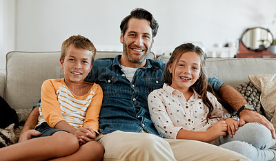 Buy stock photo Shot of a young boy and girl sitting at home with their father