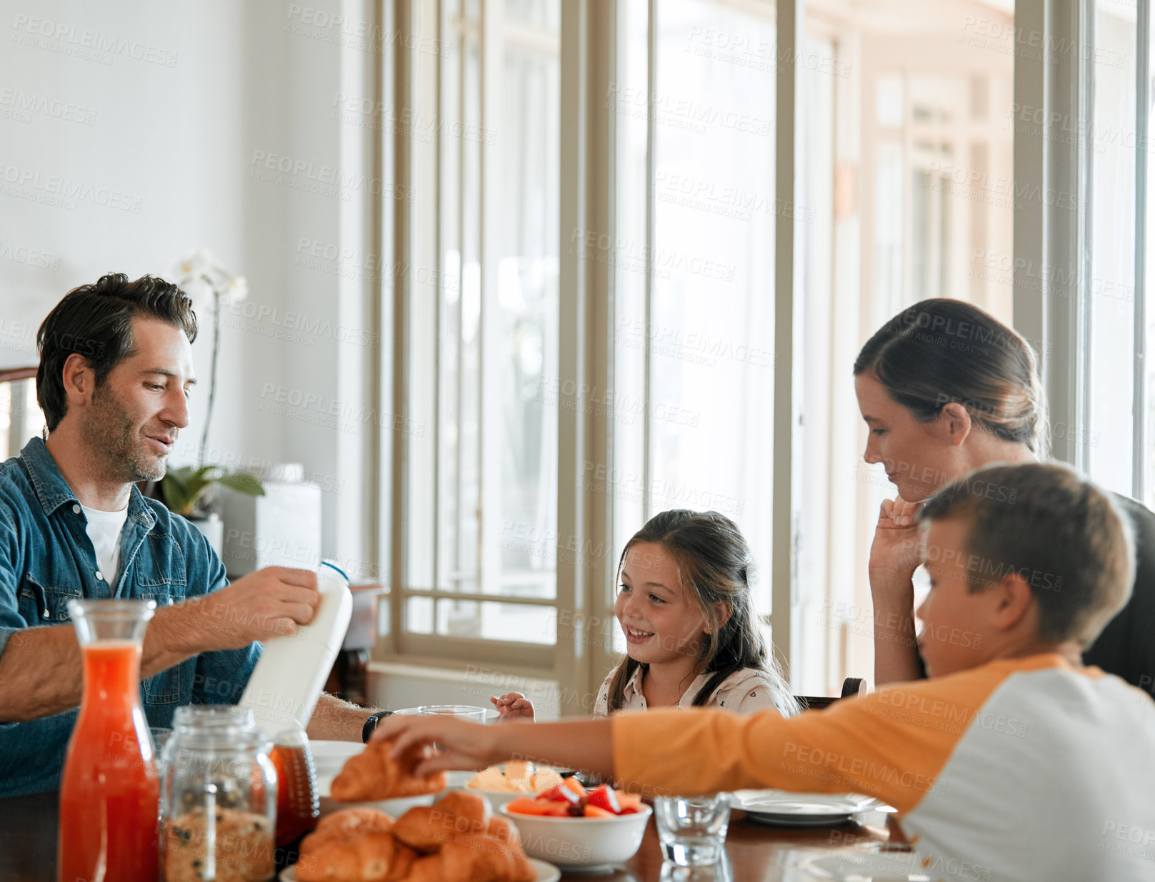 Buy stock photo Bonding, parents and kids in house with breakfast, eating together and connection on weekend break. Father, mother and children with day off, morning meal and quality time in happy relationship.