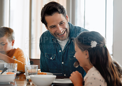 Buy stock photo Shot of a man having breakfast at home with his two young kids