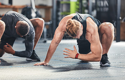 Buy stock photo Cropped shot of a group of young athletes going through their warmup routine in the gym