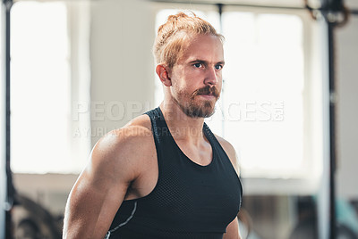 Buy stock photo Cropped shot of a handsome young man working out in the gym