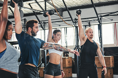 Buy stock photo Cropped shot of a group of young athletes in an exercise class at the gym