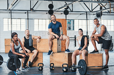 Buy stock photo Full length portrait of a group of young athletes hanging around in the gym after their workout