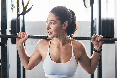 Buy stock photo Cropped shot of a young woman working out with a barbell at the gym