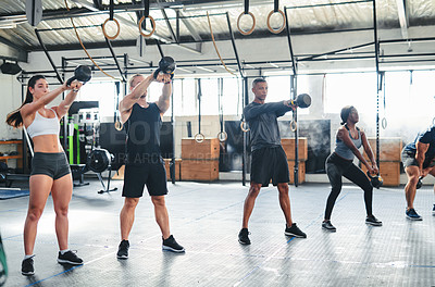 Buy stock photo Shot of a group of young athletes in an exercise class at the gym