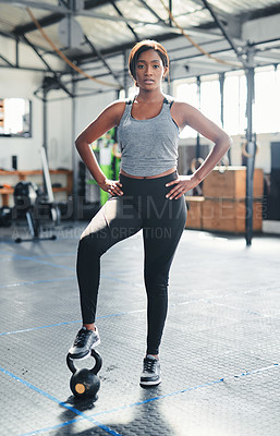 Buy stock photo Shot of a fit young woman posing with her hands on her hips at the gym
