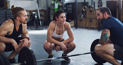 Buy stock photo Shot of a group of people taking a break while exercising in a gym