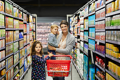 Buy stock photo Shot of a mature mother grocery shopping with her children