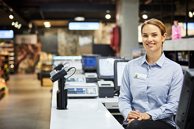 Buy stock photo Shot of a young woman working as a cashier at a supermarket
