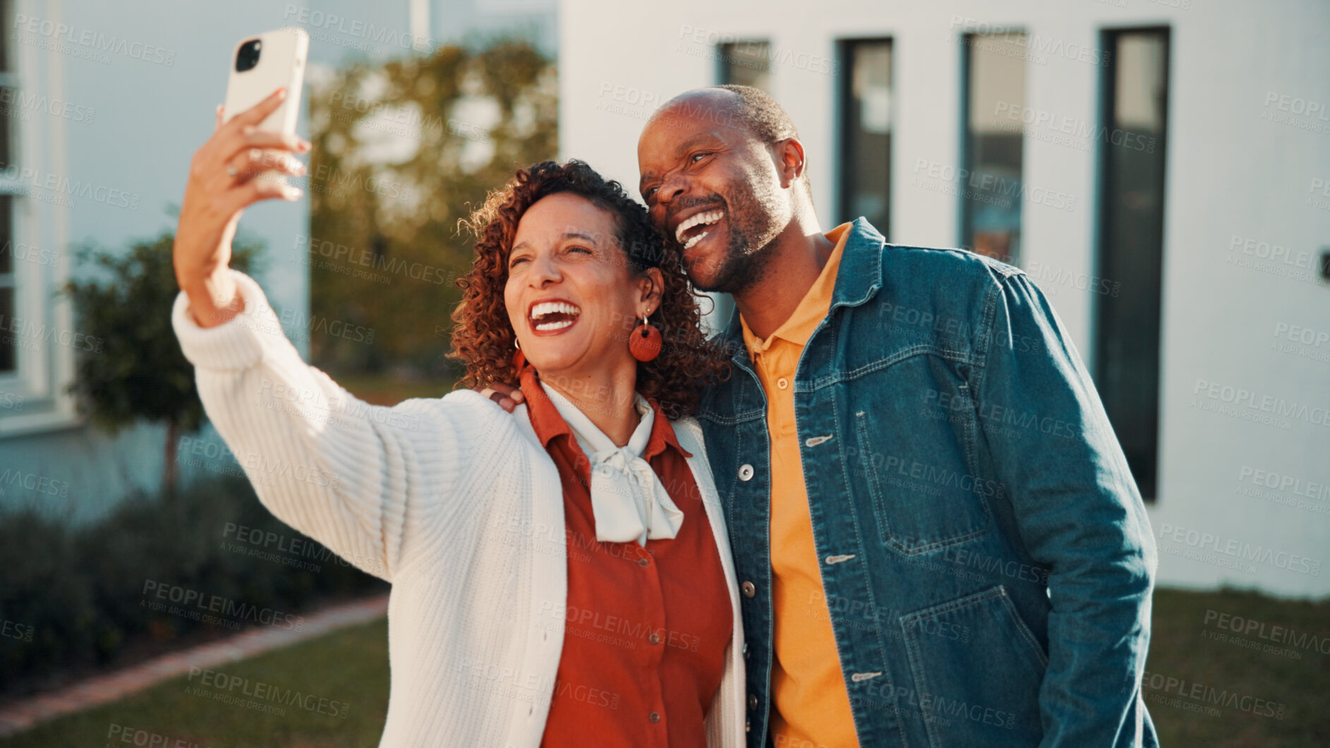 Buy stock photo Laughing, proud and selfie with African couple outdoor at new home together for property investment. Funny, hug and photograph in front yard of dream house for loan or mortgage approval and success