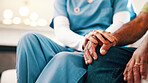 Holding hands, comfort and nurse with man in home for support in medical diagnosis, advice or checkup. Healthcare, empathy and caregiver with patient for compassion at consultation in living room.
