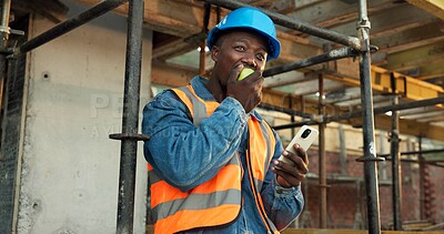 Buy stock photo Apple, break and man at construction site with phone, fruit snack and PPE for building project. Black person, reflection and eating lunch outdoor with helmet, tech and rest with infrastructure plan