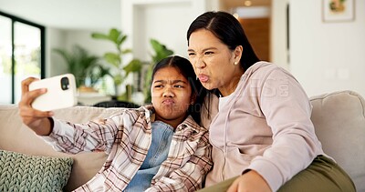 Buy stock photo Selfie, funny face and mom with child on sofa for social media, picture and memory for bonding. Family, weekend and mother with girl for silly post, photo and tongue for moment, love or relax in home