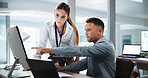Businessman, pointing and computer with coworker for analytics or performance review in office. Man, woman or showing colleague data with technology for company statistics or profit in workplace