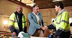 Handshake, welcome and engineer with people in warehouse for manufacturing, expansion or agreement. Construction, partner and shaking hands with employee in workshop for contractor deal and woodwork