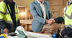 Handshake, b2b and engineer with people in warehouse for  manufacturing, expansion and agreement. Construction, partner and shaking hands with employee in workshop for contractor deal and woodwork