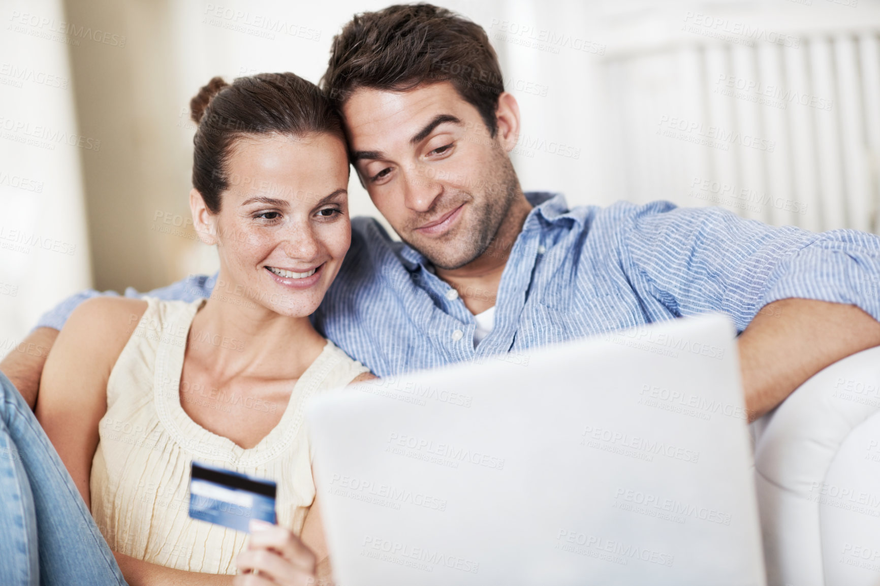 Buy stock photo Credit card, laptop and reading with couple on sofa in home for travel planning, payment and flight booking. Airline ticket, holiday budget and honeymoon research with man and woman in living room