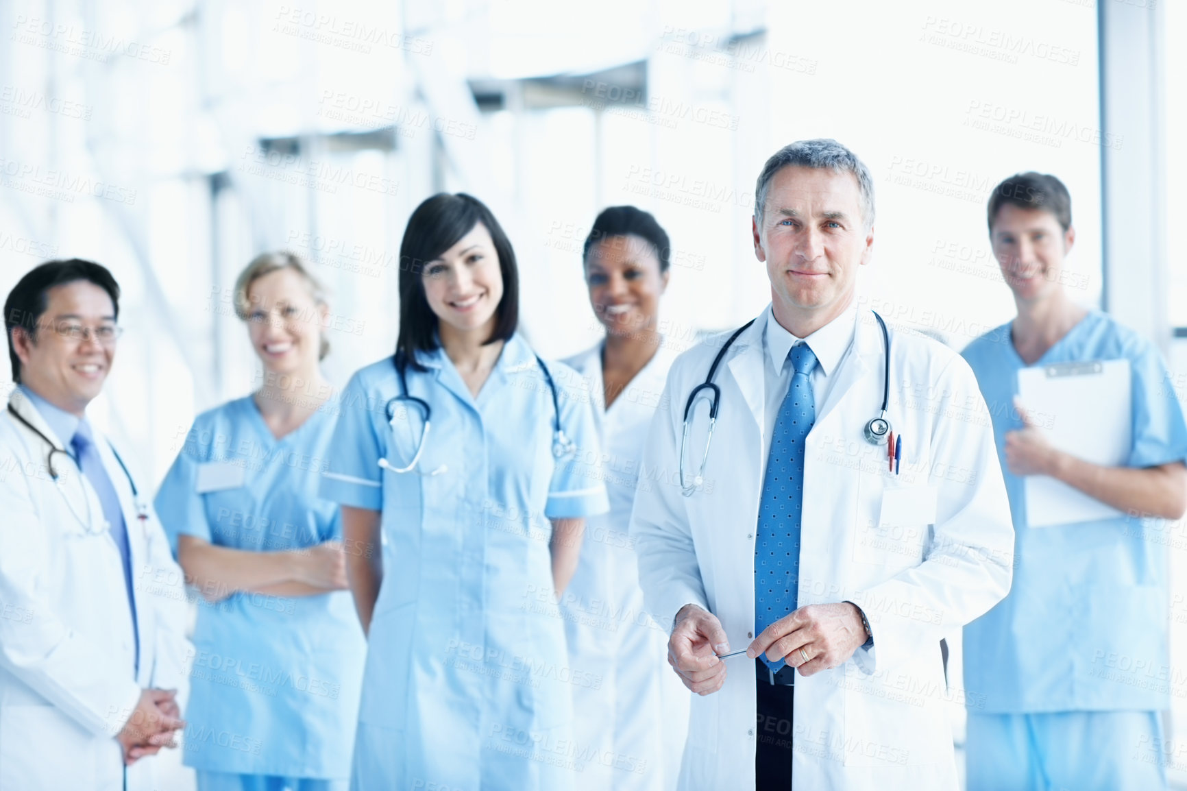 Buy stock photo Team, portrait and smile with man in hospital for healthcare, nurse solidarity and consulting. Medical, community and about us with people in lobby of clinic for support, doctors and collaboration