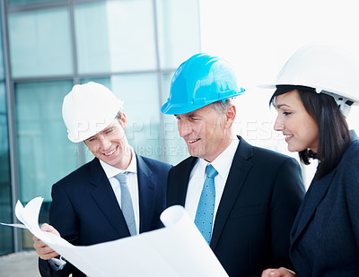Buy stock photo Blueprint, architect and team with business people in city for urban developer, engineer and smile. Construction layout, floor plan and designer with employees for meeting and project management
