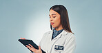Tablet, woman and scientist in studio with medical research, innovation or pharmaceutical report. Digital technology, reading and biologist with science project for healthcare on blue background.