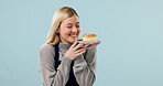 Happy, woman and waitress in studio with dessert, bakery treats or excited for coffee shop hospitality. Person, cafe worker and customer service with smile, cake and mockup space on blue background.