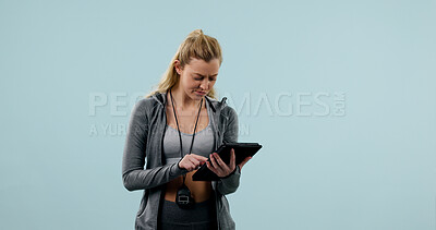 Buy stock photo Tablet, woman or personal trainer in studio with fitness, mockup space or confused for wellness trend. Workout coach, person and scroll with tech, website or doubt for exercise fad on blue background
