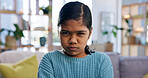 Upset, serious and portrait of child on sofa in home with bad attitude, development or growth. Angry, relax and girl kid in living room with disappointment, mad or moody for behavior problem in house