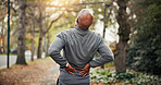 Fitness, stretch or old man in park with back pain, hurt spine or joint health in wellness hobby. Arthritis, sore or senior person with warm up, muscle strain or injury prevention in outdoor activity