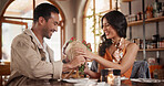 Love, happy or couple in restaurant with flowers, relationship gift or bonding in anniversary celebration. Commitment, present or people with bouquet, special moment or connection with romantic date.