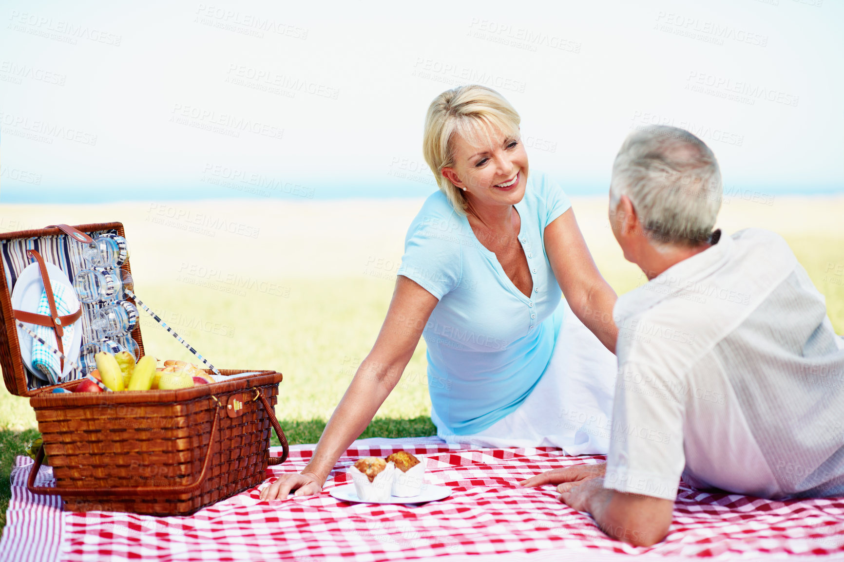 Buy stock photo Senior, woman and couple picnic outdoor for anniversary, day trip and bonding with conversation. Nature, happy people and snacks on blanket for romantic date, holiday outing and retirement connection