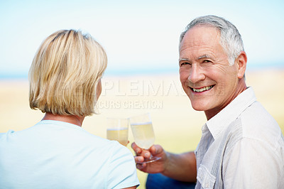 Buy stock photo A cropped portrait of a happy mature man drinking champagne outdoors with his wife