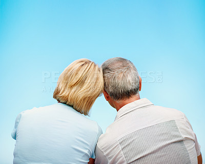 Buy stock photo A cropped rear view shot of an affectionate mature couple sitting outdoors