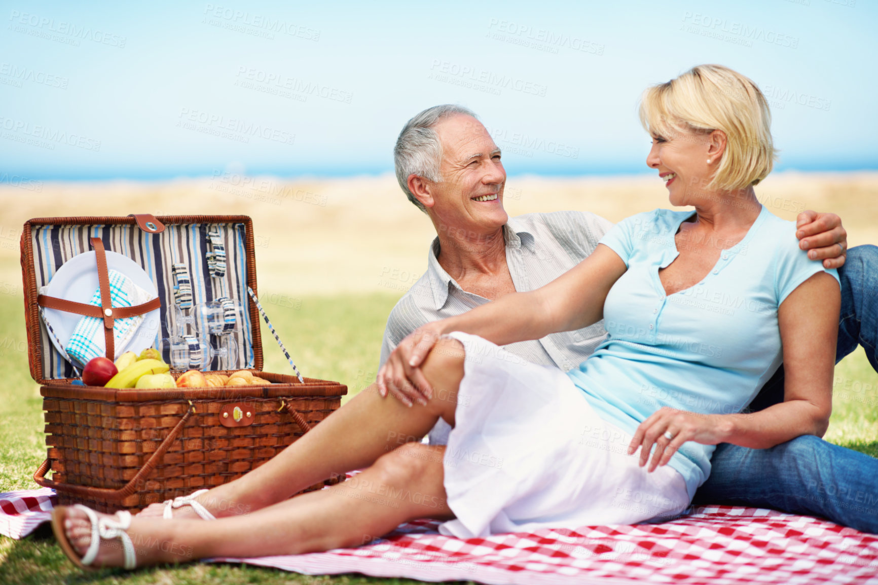 Buy stock photo Senior, couple and relax at picnic in nature for anniversary, connection or healthy marriage. Love, happy people or talking on blanket outdoor for romantic date, weekend outing or retirement support