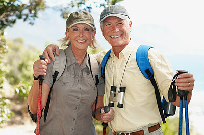 Buy stock photo Shot of an adventurous senior couple walking together in the forest