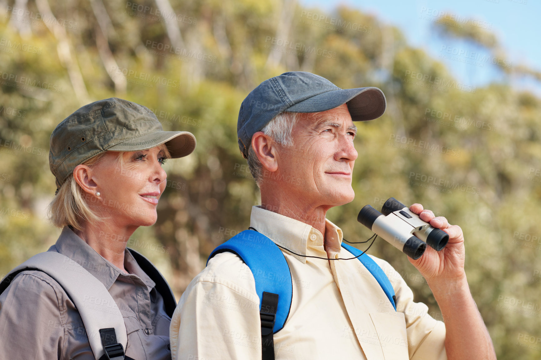 Buy stock photo Binoculars, trekking and smile with old couple in nature for view, adventure and explore. Birdwatching location, search and hiking guide with senior man and woman outdoor for retirement vacation