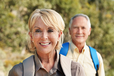 Buy stock photo Shot of an adventurous senior couple walking together in the forest