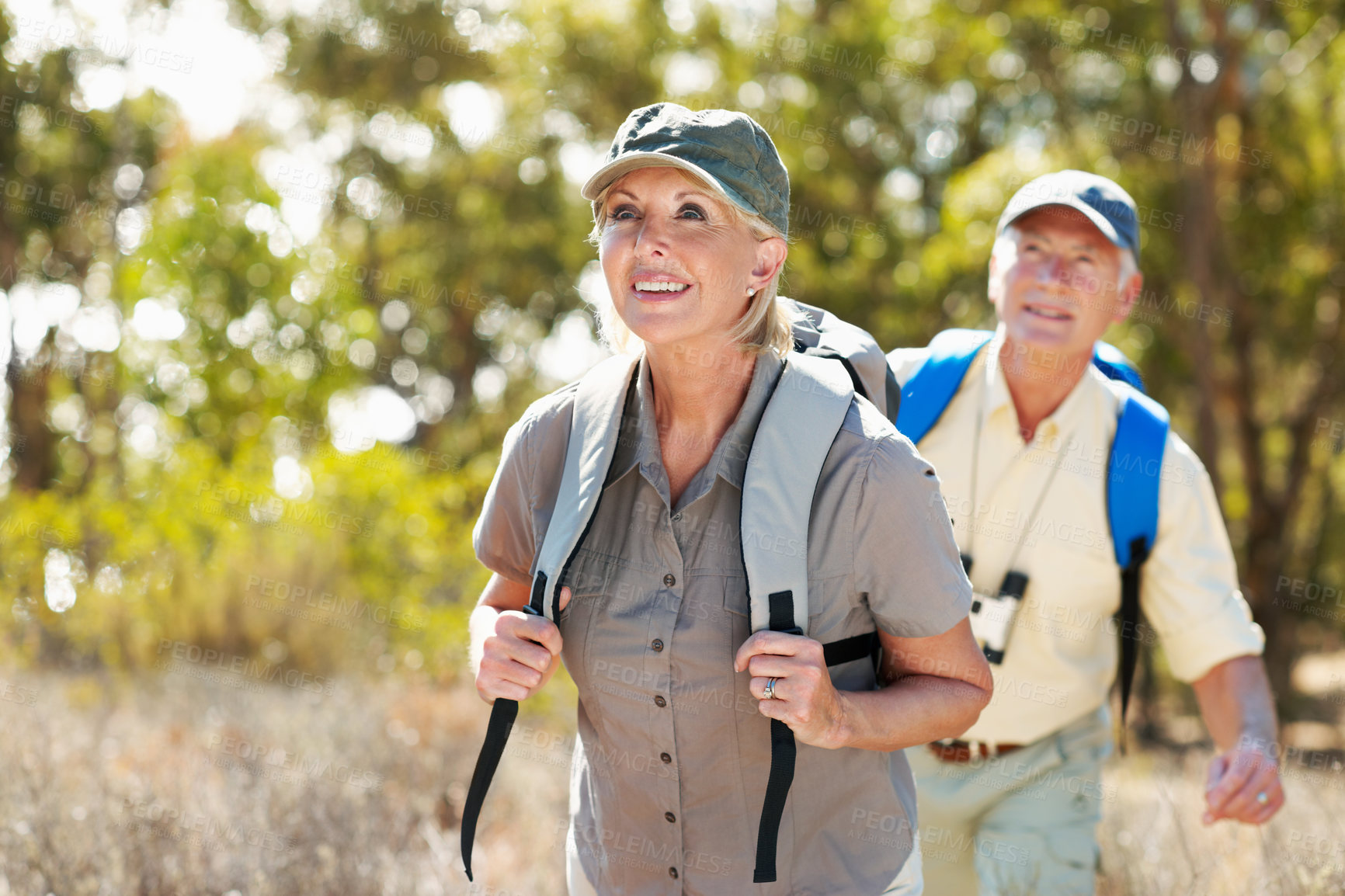 Buy stock photo Travel, hiking and senior couple outdoor in forest for adventure, bonding or backpacking. Happy, nature and elderly man with woman for trekking in woods for exploring on holiday or vacation together.