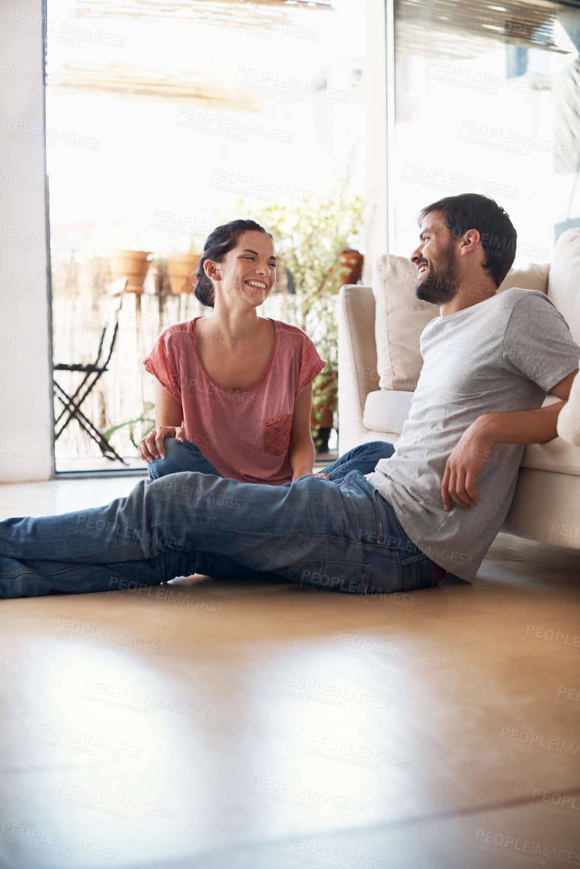 Buy stock photo Couple, laugh and relax on break in lounge, bonding or relationship commitment with partner in home. Happy people, rest and connection with spouse in living room, love and chilling together in house