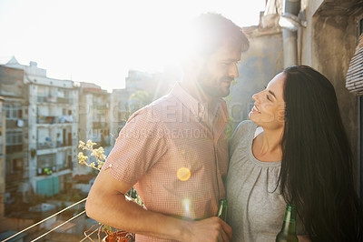 Buy stock photo A loving couple standing on a balcony of their apartment