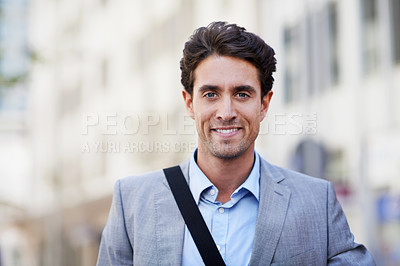 Buy stock photo An attractive businessman smiling while in the city central