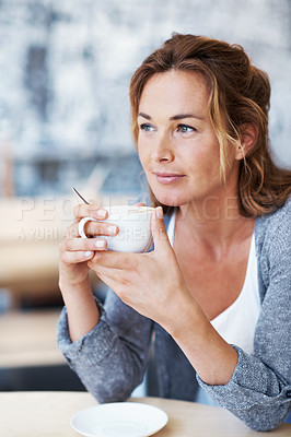 Buy stock photo Woman sitting in coffee shop holding her coffee looking contemplative