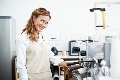 Buy stock photo Portrait of a pretty barista using the coffee machine
