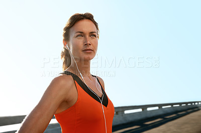 Buy stock photo Young woman looking away from the camera while standing on a highway
